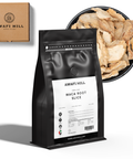 Black bag of Awafi Mill Maca Root Slice with a bowl of maca root slices and a cardboard box in the background.
